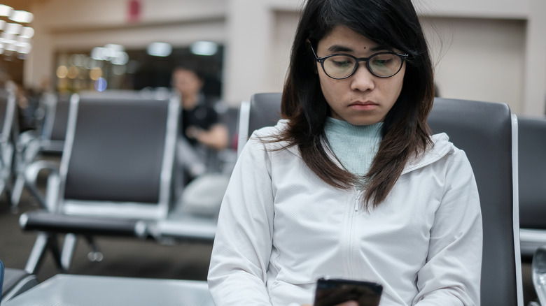 Stressed person on phone at airport
