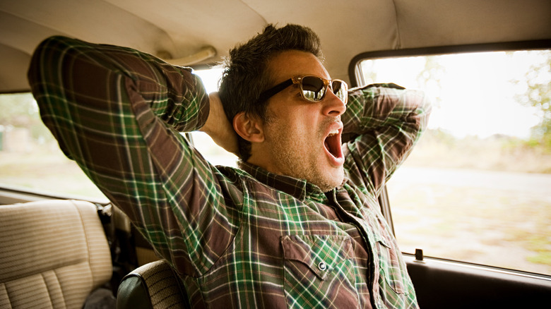 Road trip traveler yawning