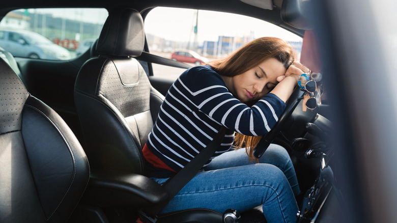 Woman sleeping at the wheel