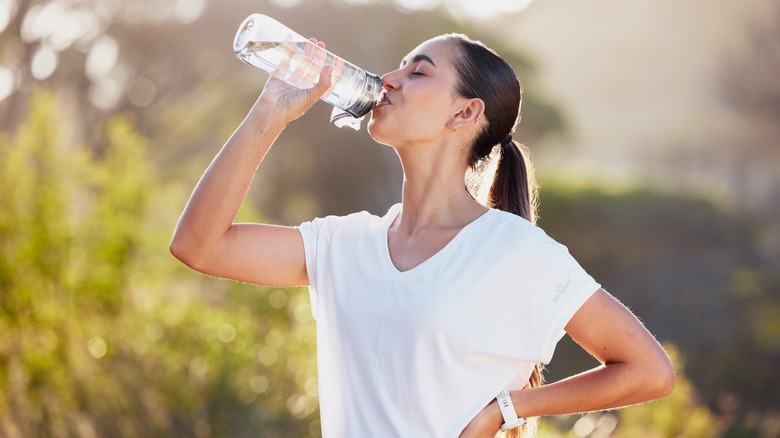 Woman drinking water outside