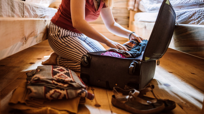 Traveler unpacking their suitcase