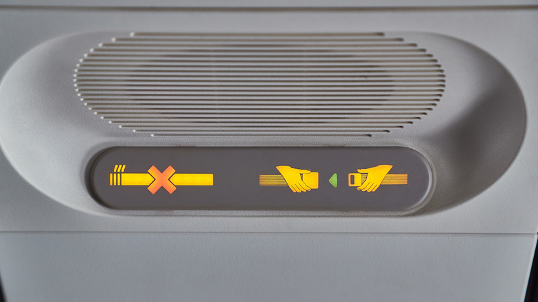 Overhead seatbelt sign on airplane