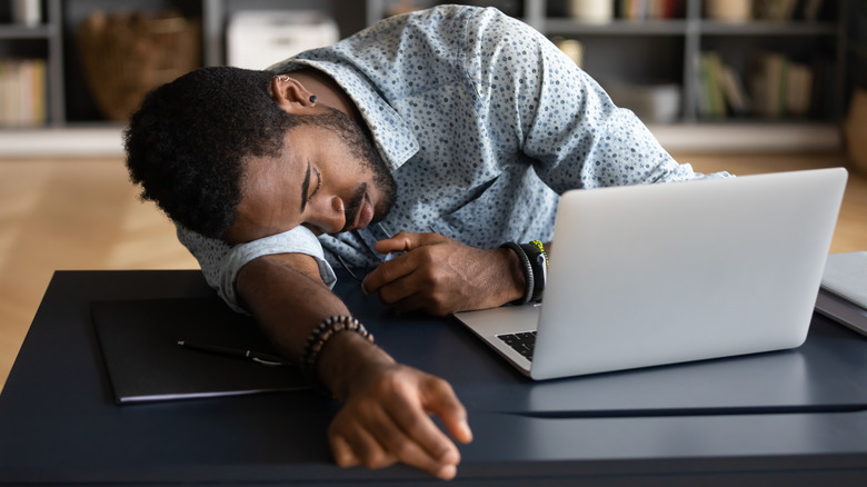 Man falling asleep at his desk