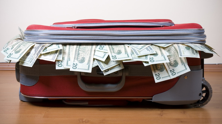 a suitcase stuffed with twenty dollar bills