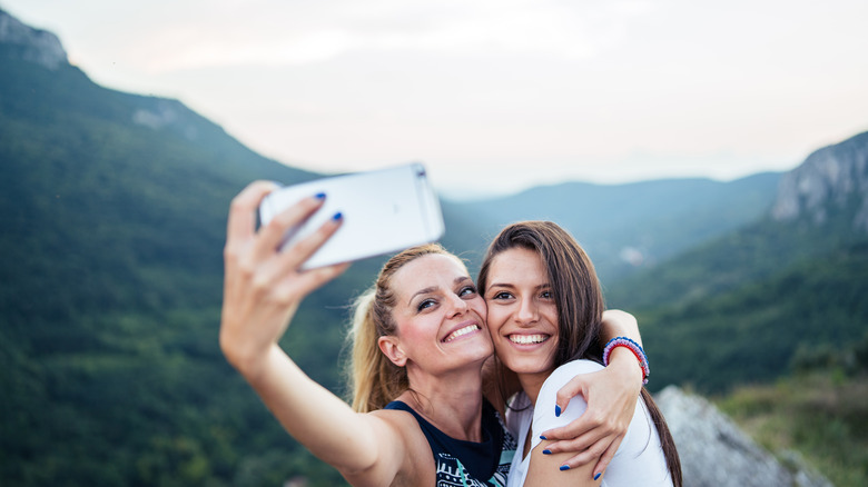 girls taking selfie outdoors