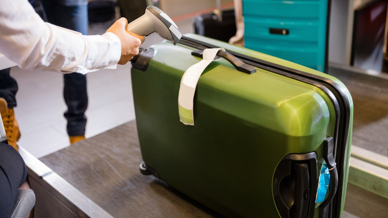 Green suitcase with tag