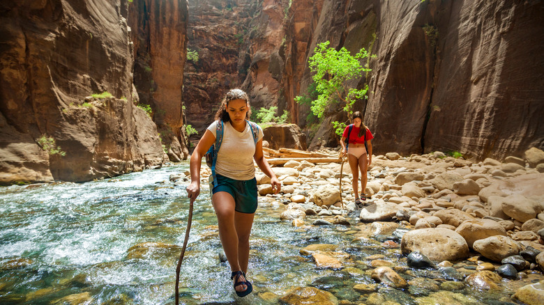 hiker in shallow river 