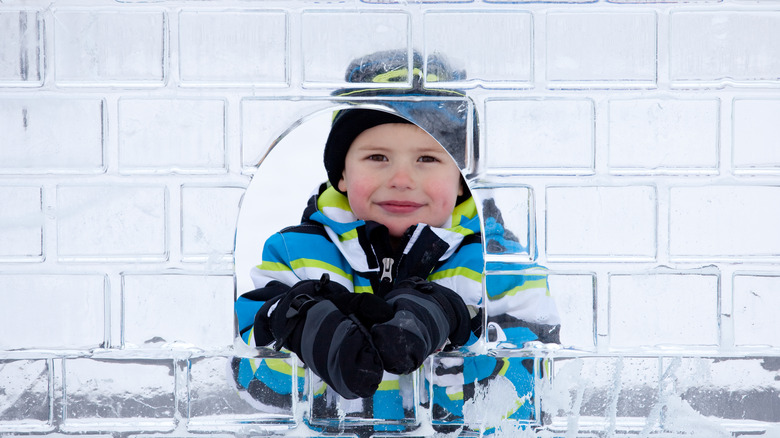 Little boy looking through ice