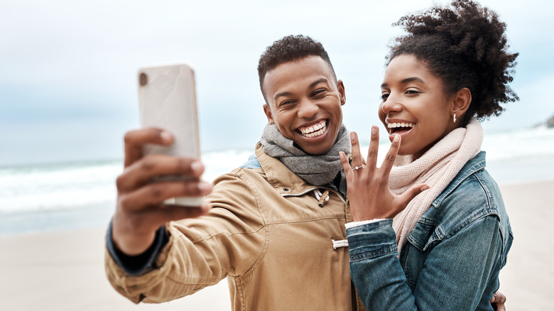 engaged couple taking photo