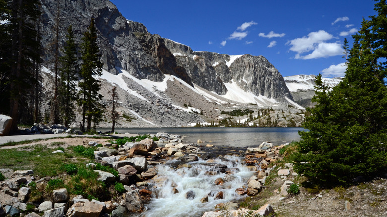 lake and waterfall surrounded by mountains