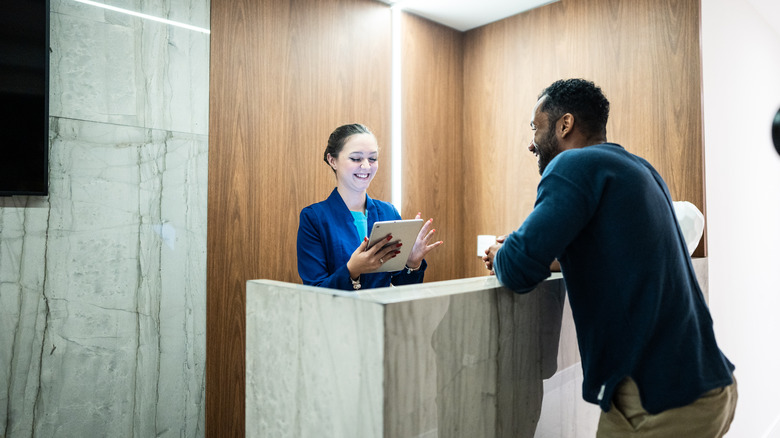 man checking in at desk