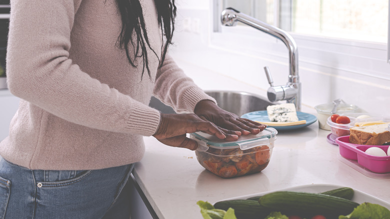 Woman packing food in containers