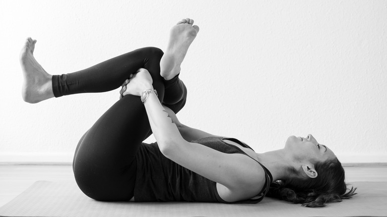 person performing supine pigeon pose