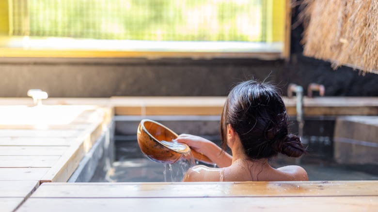 Woman enjoying typical Japanese onsen