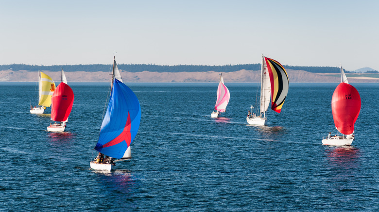 Clipper race sailboats sailing next to each other