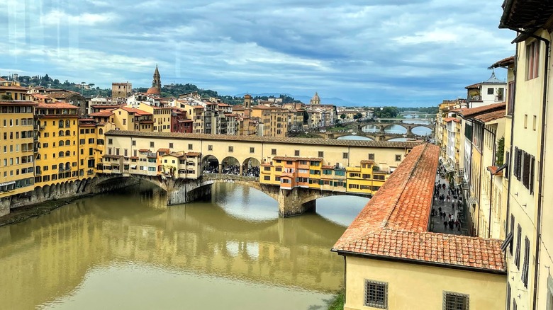 Bridge with colorful buildings over a river