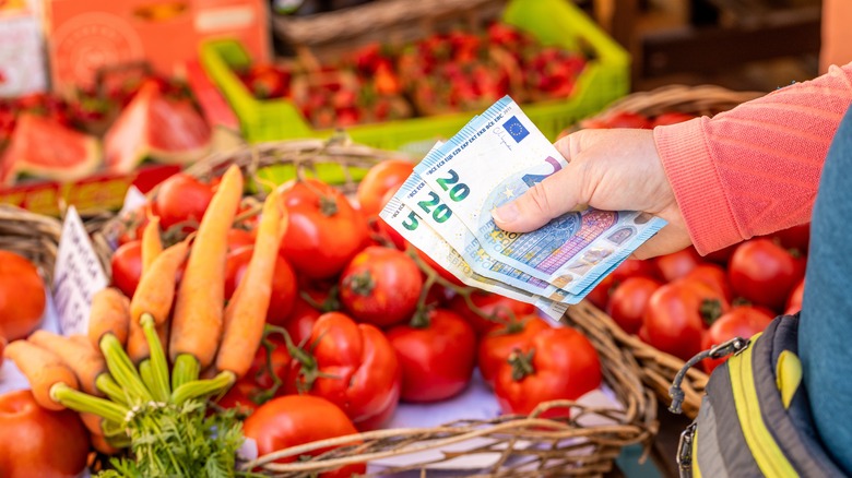 person paying for food at a European market