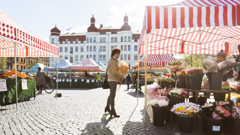 A woman strolls through an outdoor market