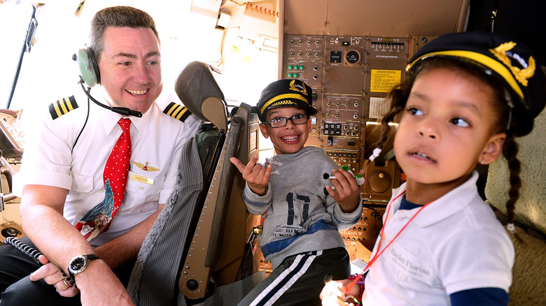 Delta pilot kids excited in cockpit