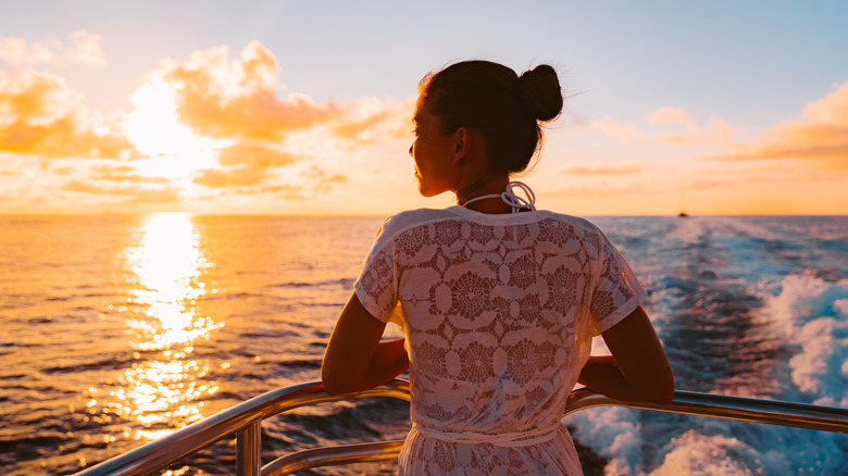 Cruise ship woman watching sunset