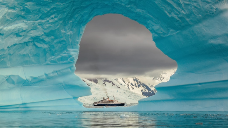 Steamer ship seen through an iceberg in Drake Passage, Antarctica