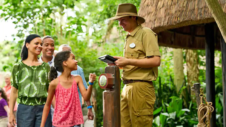 Girl scanning MagicBand at ride entrance