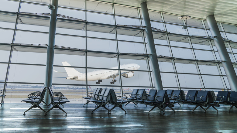 empty airport with departing plane