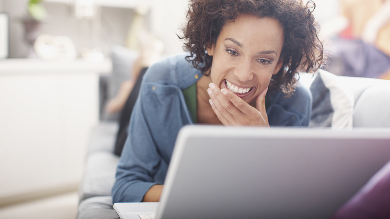 woman smiling at laptop