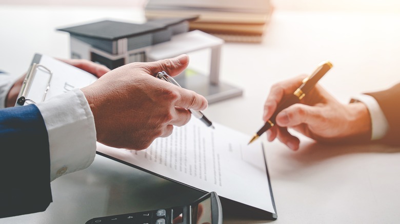 People signing documents