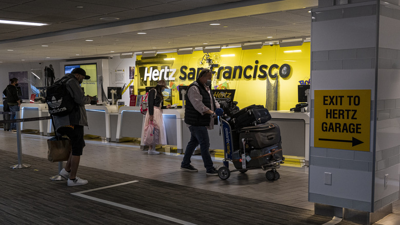 Hertz rental desk with customers.