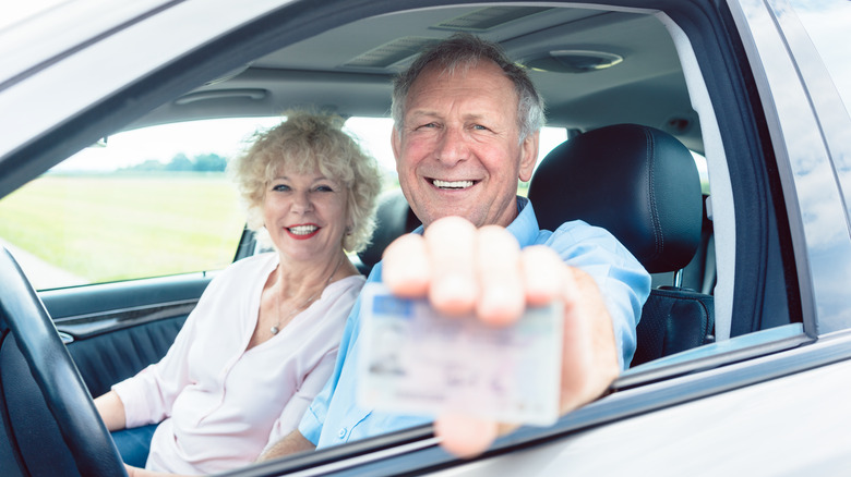 Couple showing driver's license