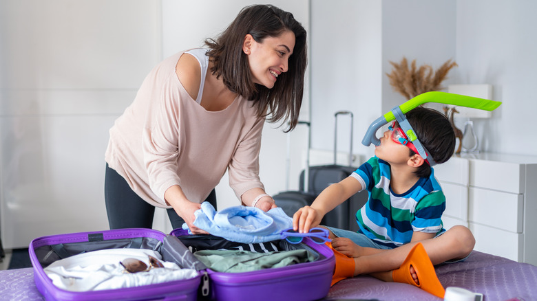 mom and son packing suitcases
