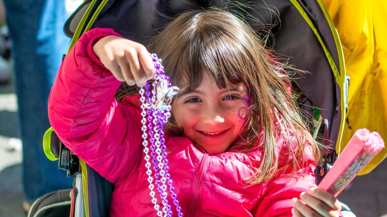 girl with Mardi Gras beads