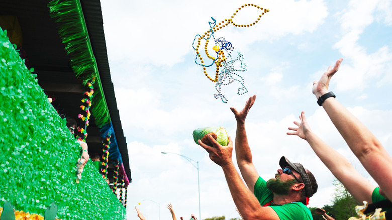 throwing beads during Mardi Gras