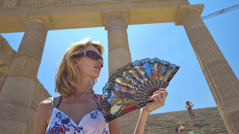 Woman fanning herself at Acropolis